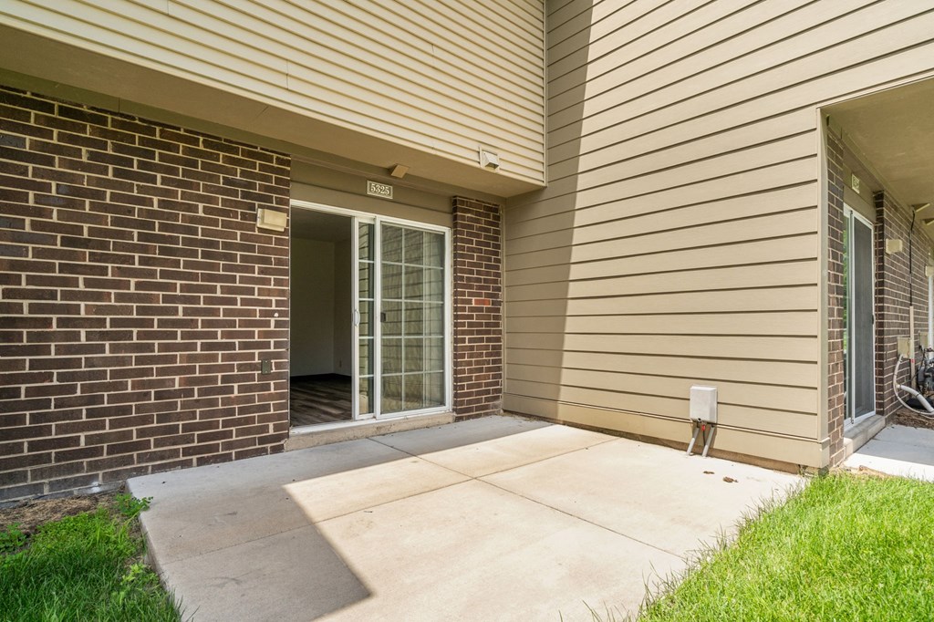 the outlook of a patio in a home with the door open