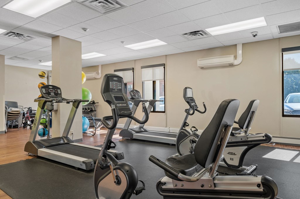 a gym with treadmills and other exercise equipment