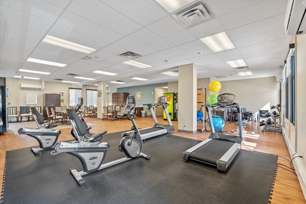 a gym with treadmills and other exercise equipment