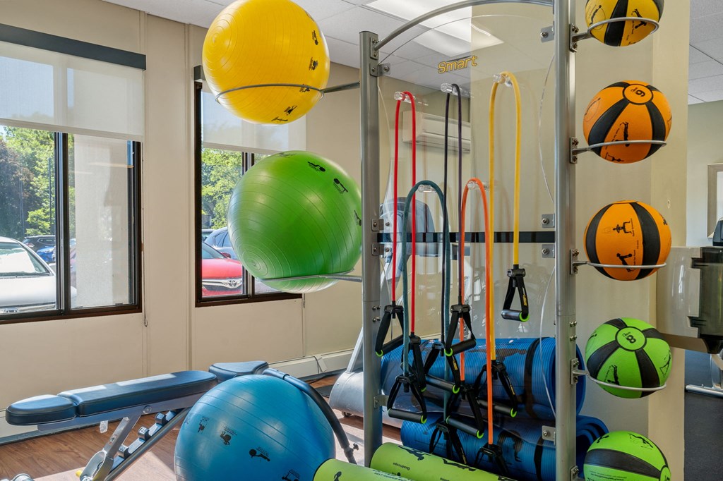 a fitness room with weights and cardio equipment in a building