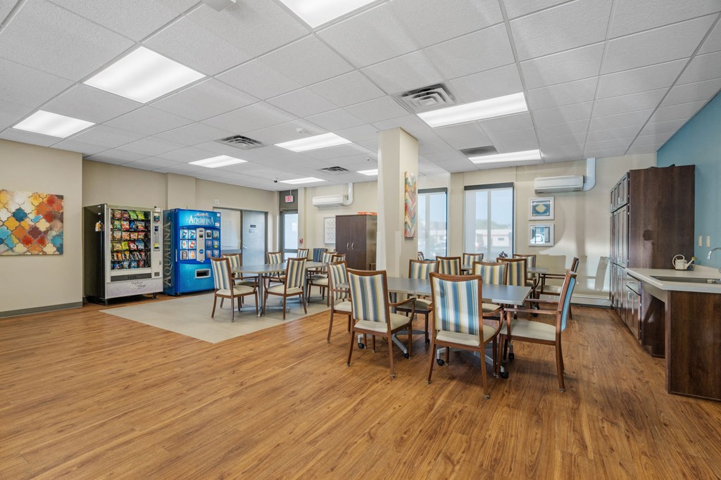 a dining room with tables and chairs and aacistacist in the front of a