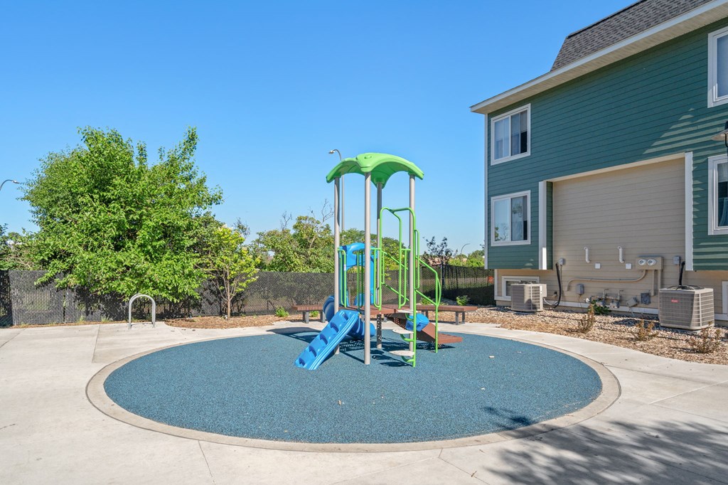 a swing set in the middle of a playground