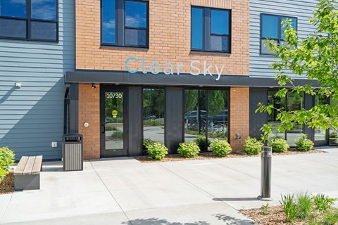 Clear Sky building with a bench in front.