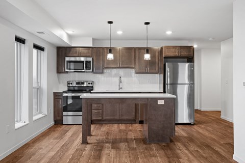 a kitchen with wooden cabinets and stainless steel appliances