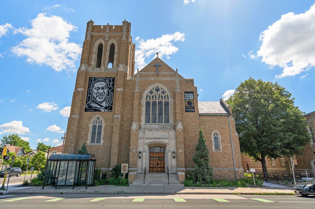 an old church with a mural of a man on the front