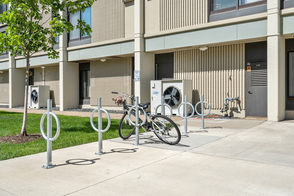 a row of bikes parked in front of a building