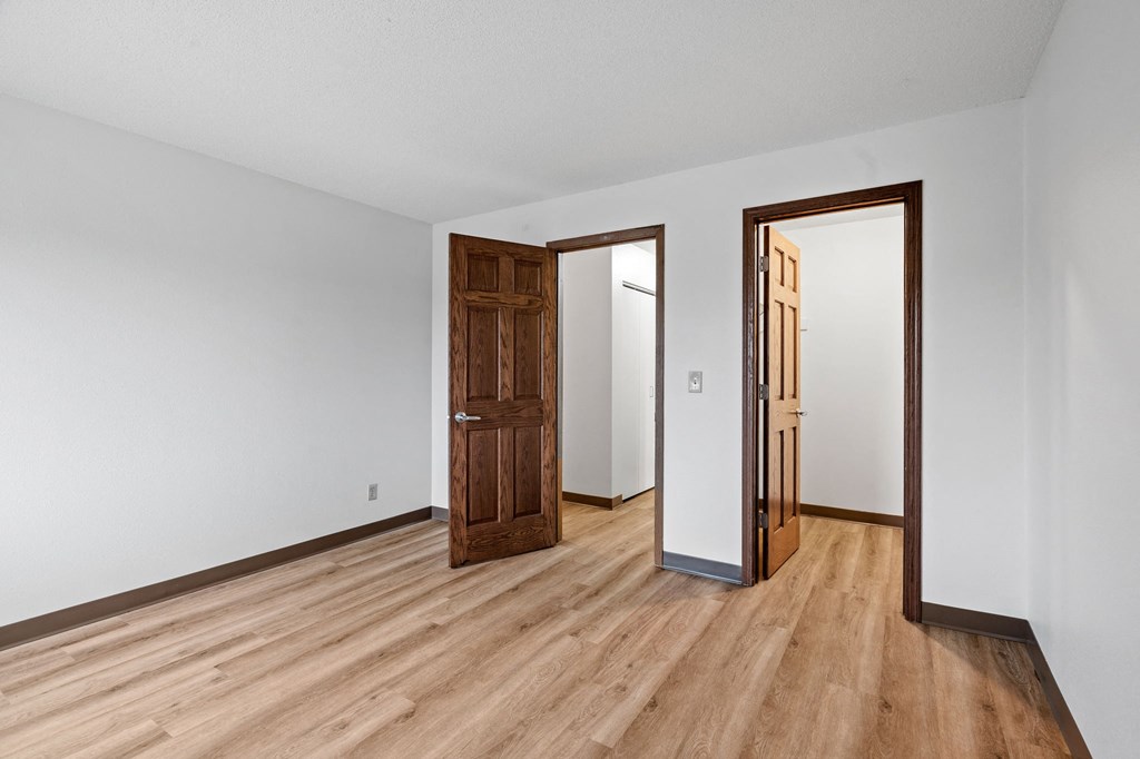 a living room with wood floors and white walls