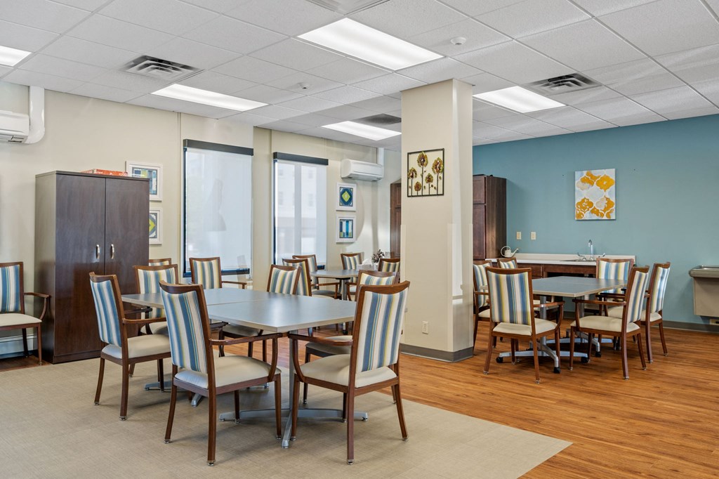 a dining room with tables and chairs and a wall with surfboards