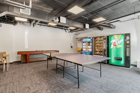a room with a ping pong table and a pool table
