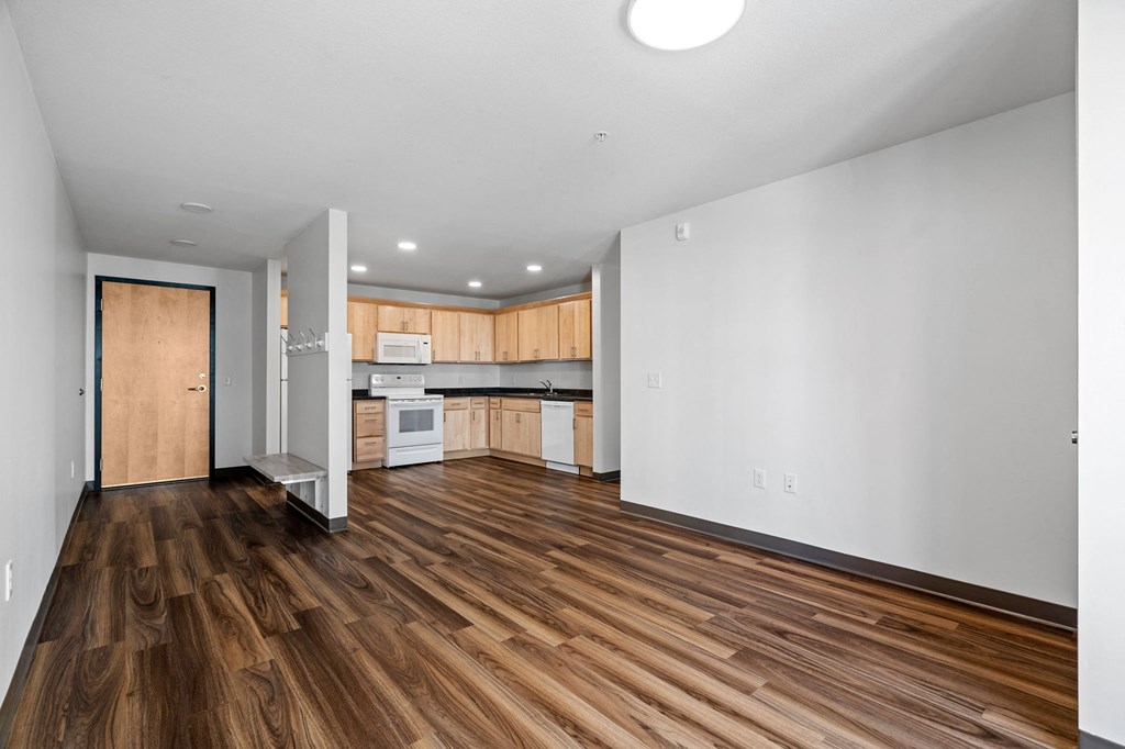 a view of a kitchen and a living room with a hard wood floor