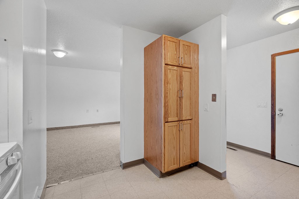 an empty room with a closet in the middle of it