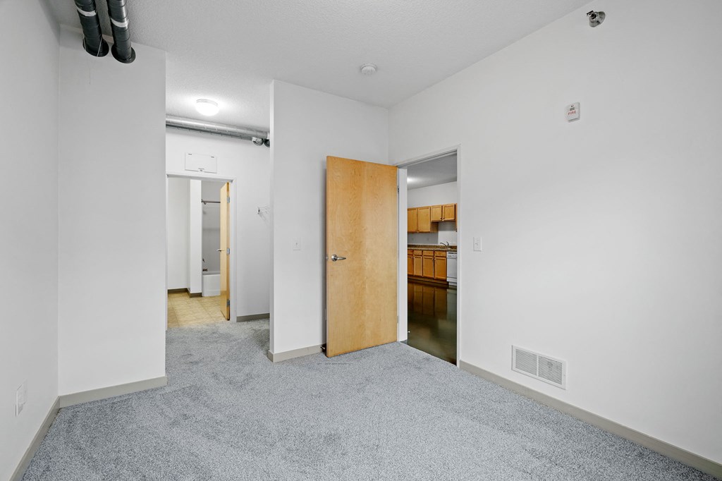 a hallway with vaulted ceilings and white walls with polka dot wallpapers