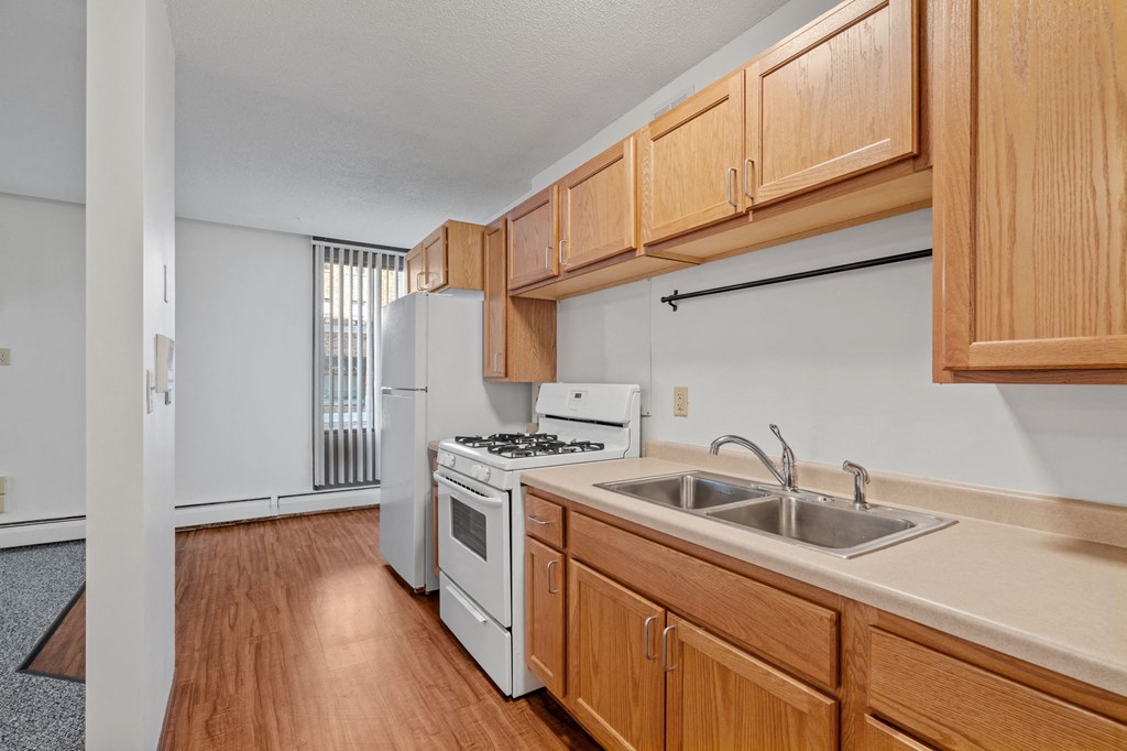 a kitchen with white appliances and wooden cabinets