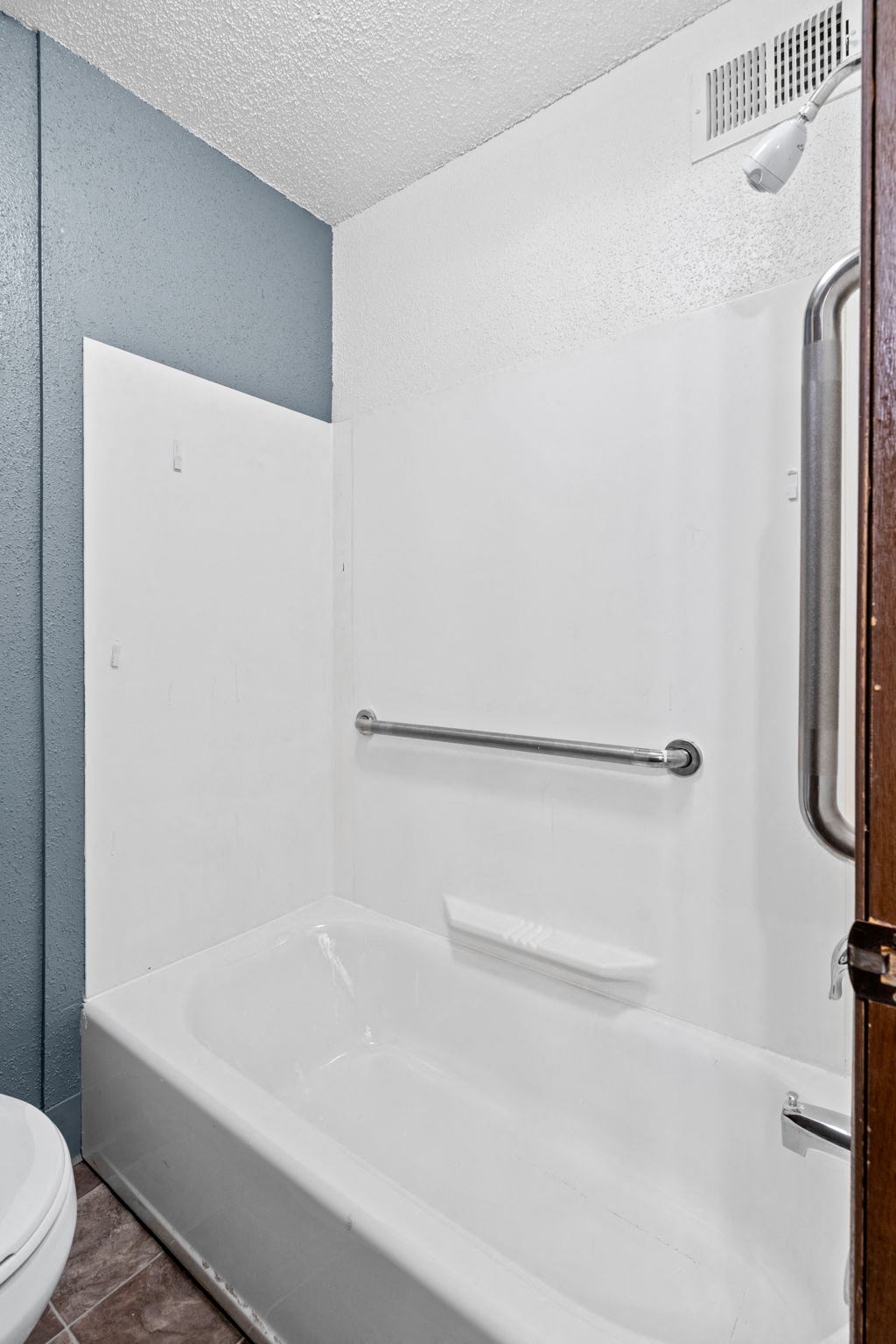 a bathroom with a shower and a sink and a toilet