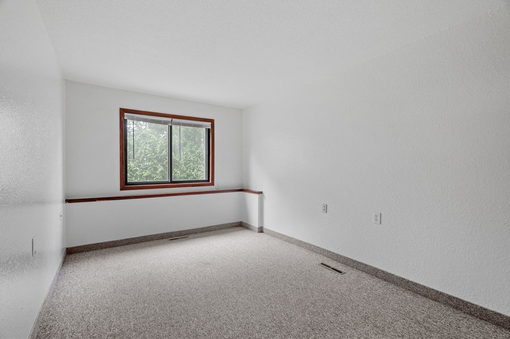 the living room of an empty house with a window