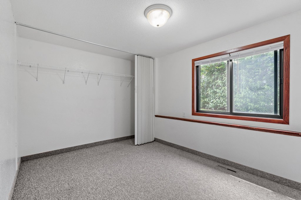 the living room of an empty house with a large window