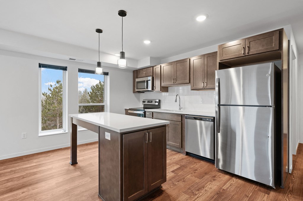 a kitchen with stainless steel appliances and wooden cabinets