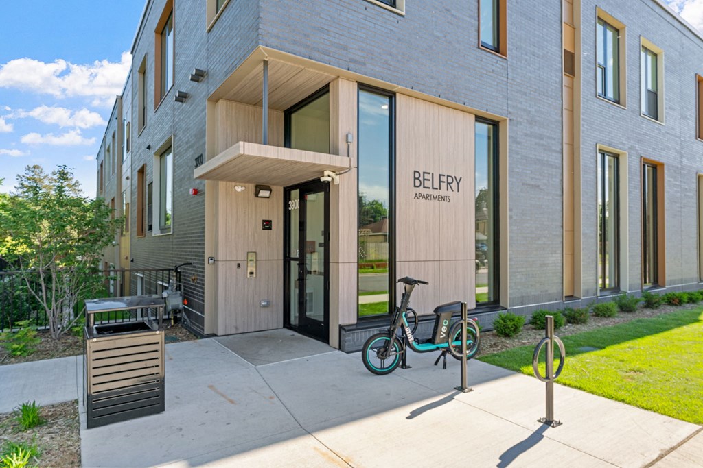 a bicycle parked in front of a building with the door open