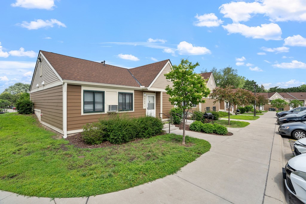a row of houses in a neighborhood with cars parked on the sidewalk