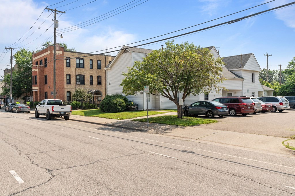a white truck driving down a street in front of a brick building