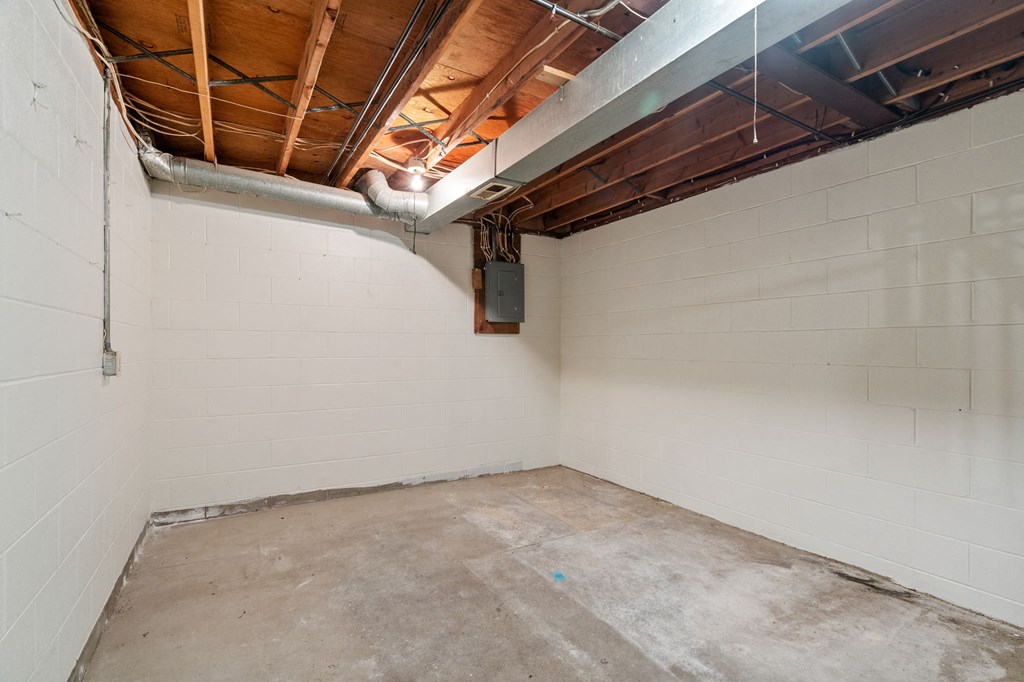 the interior of a room with a concrete floor and white walls