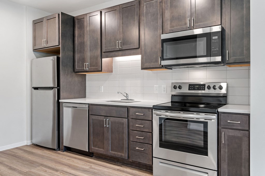 a kitchen with stainless steel appliances and wooden cabinets