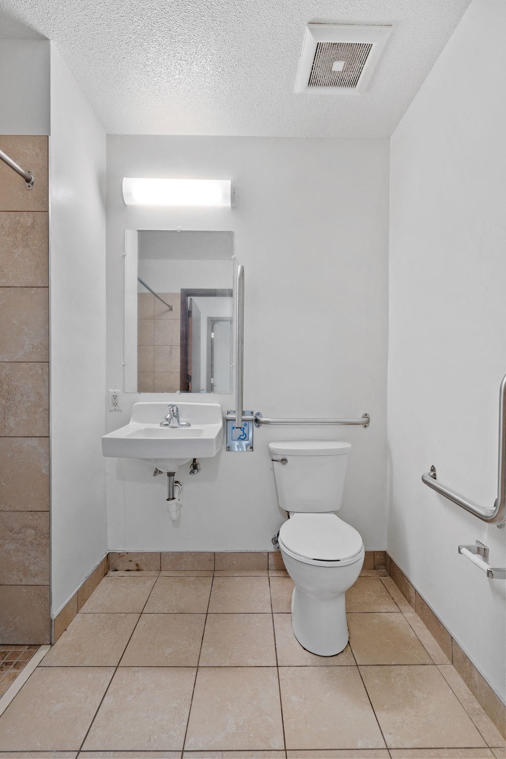 a bathroom with a toilet and a sink and a mirror