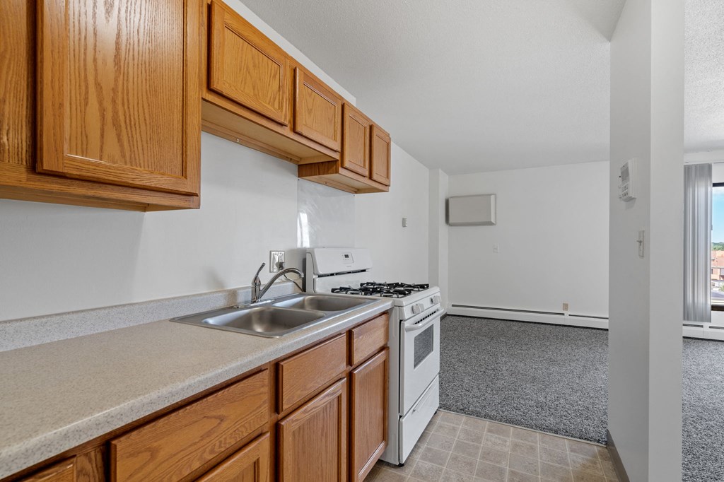 a kitchen with white appliances and wooden cabinets