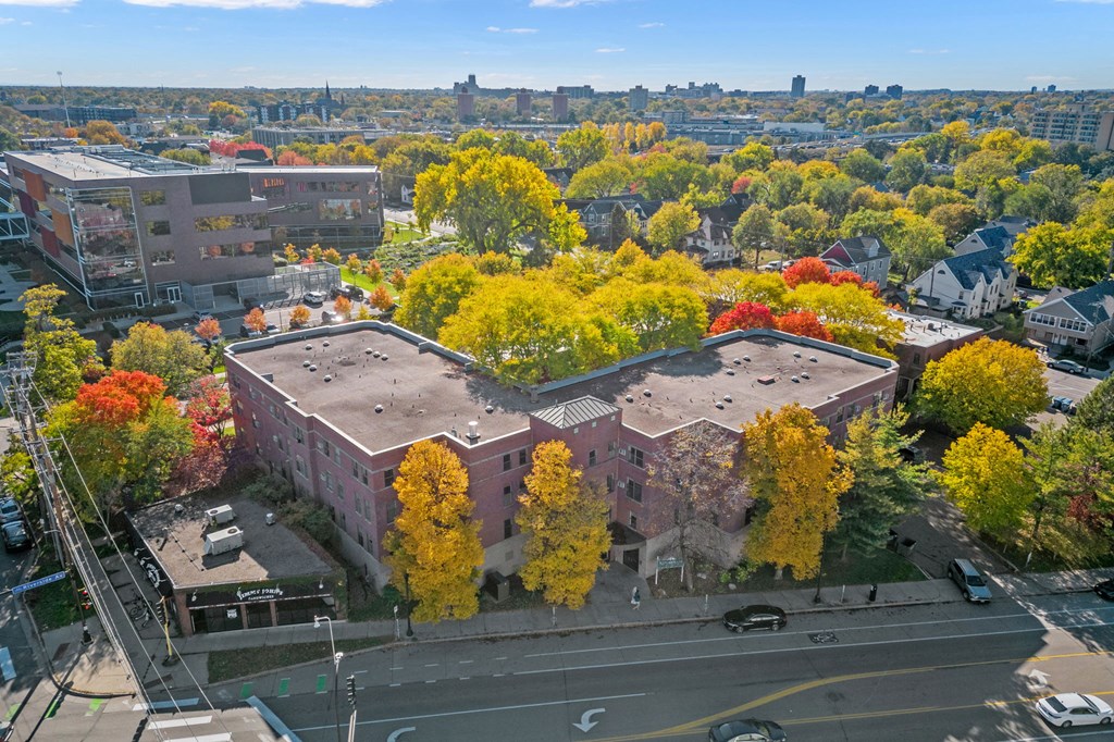 an aerial view of a building in a city with trees