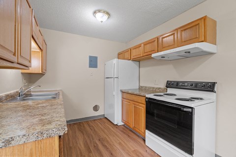 a kitchen with white appliances and wooden cabinets