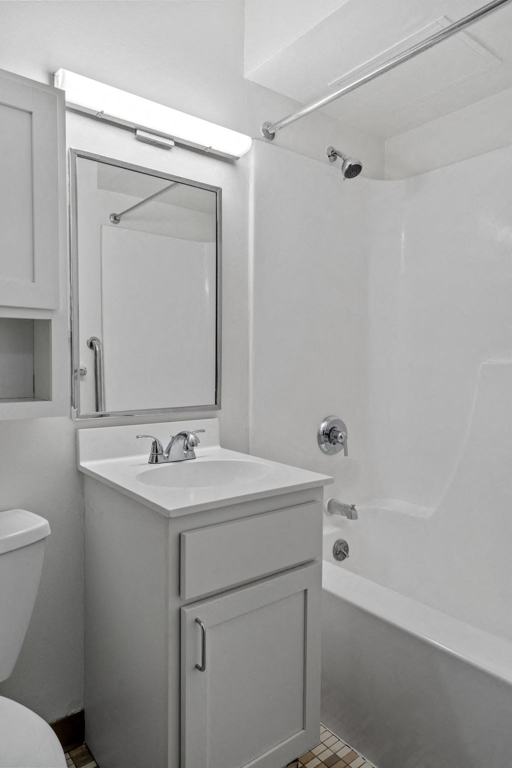 a white bathroom with a sink and a mirror