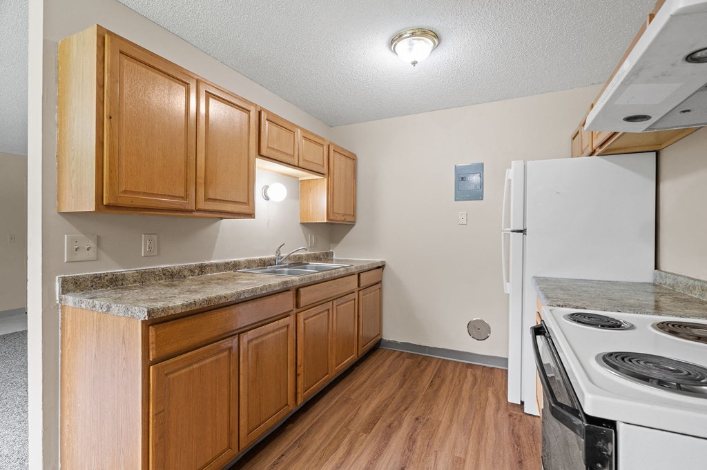 a kitchen with a stove refrigerator and a sink