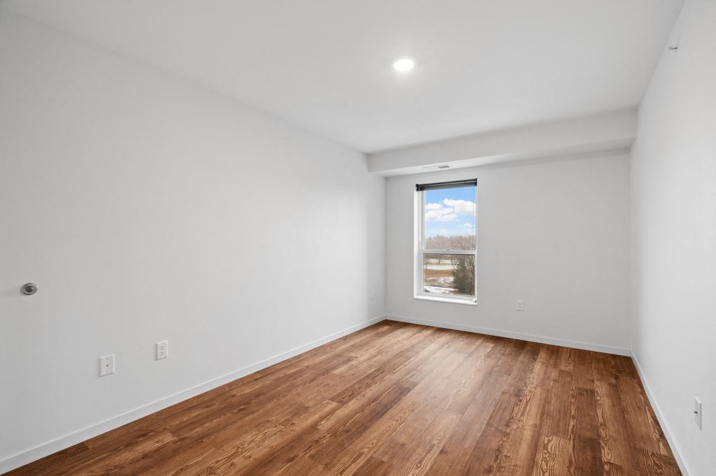 a living room with white walls and a window