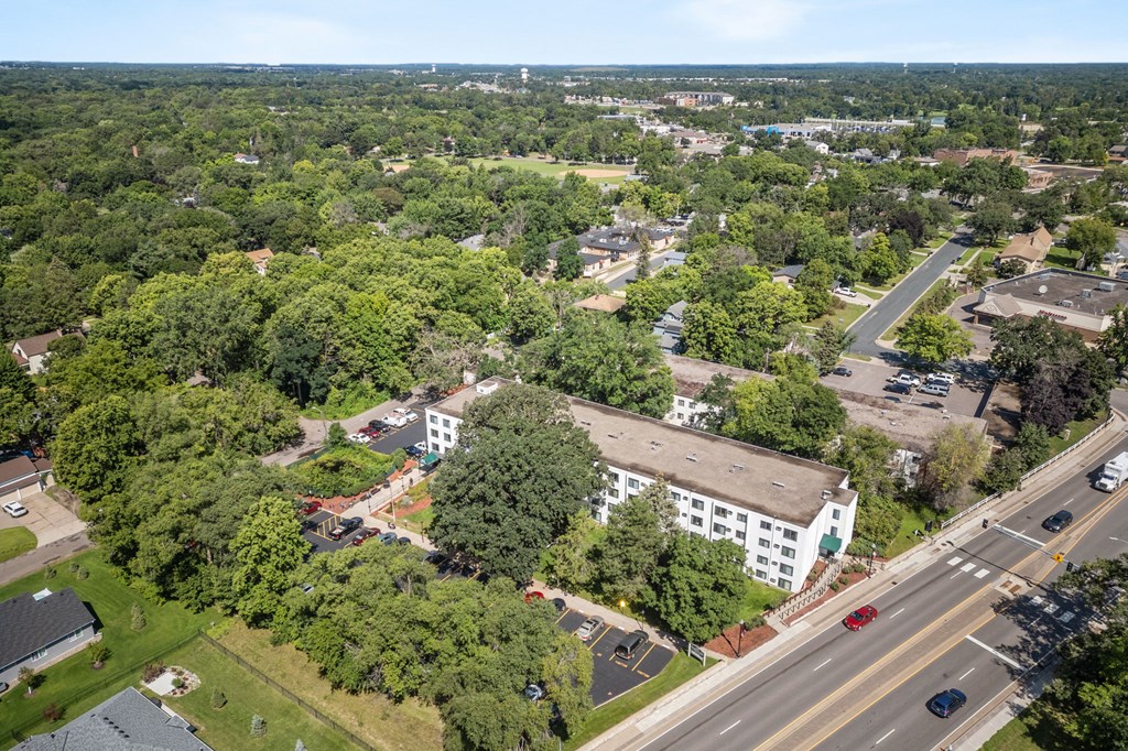 an aerial view of a city with a road and buildings