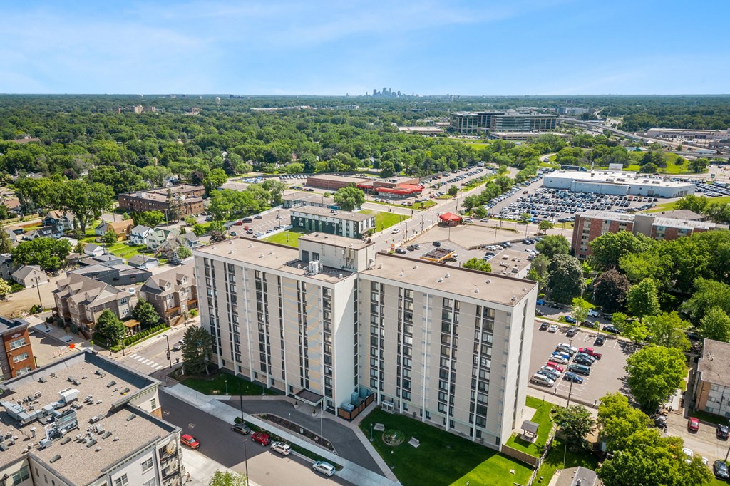an aerial view of a city with tall buildings and a parking lot