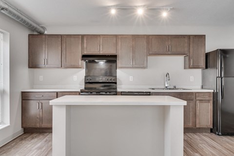 a kitchen with wooden cabinets and a white counter top