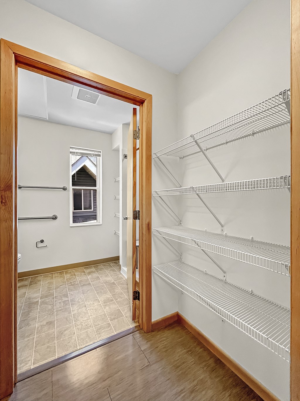 an empty room with an open door to an empty closet