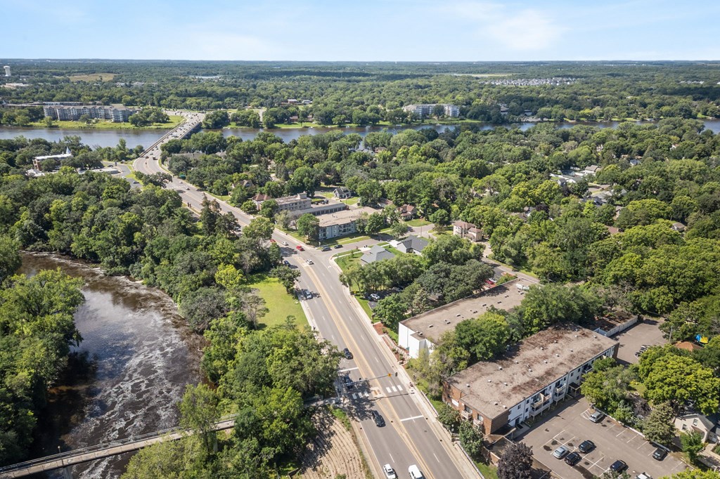 an aerial view of a city with a highway and a river