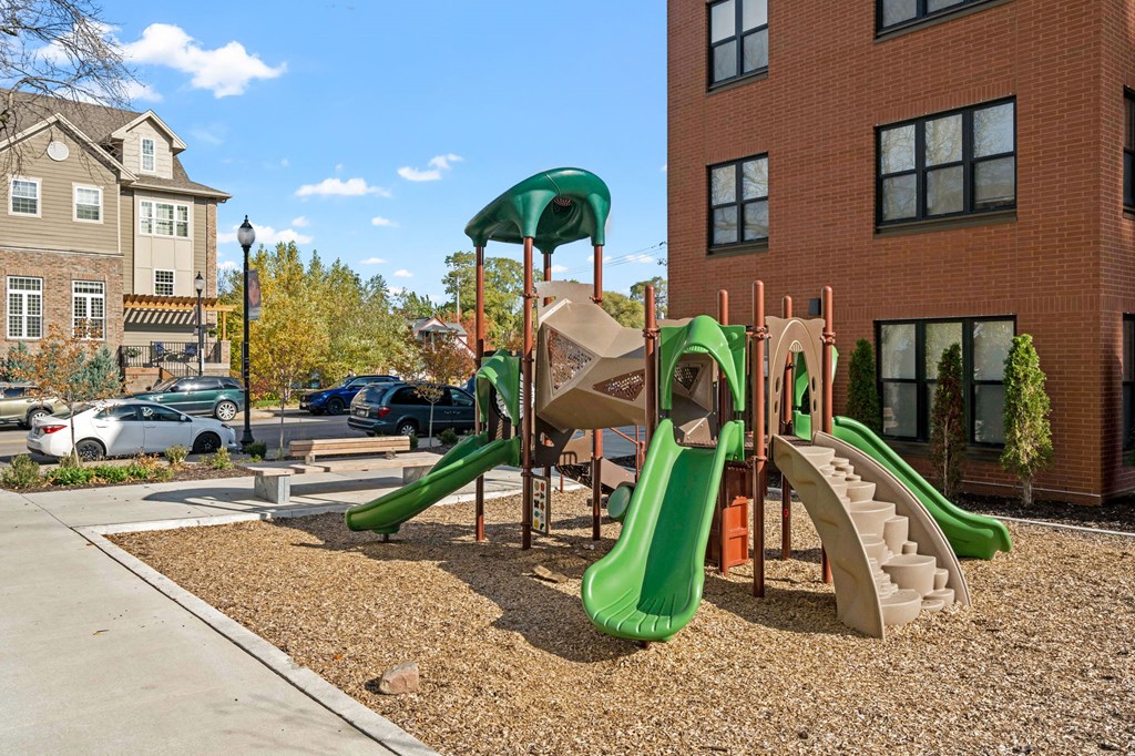 a playground with slides in front of a building