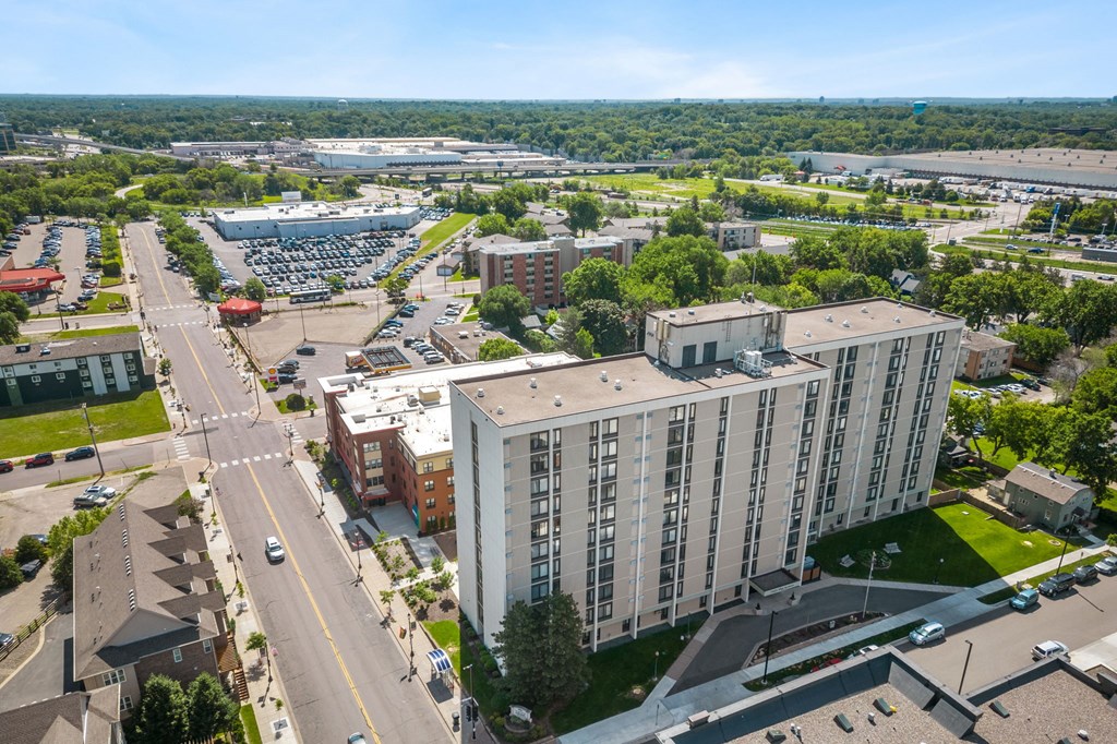 an aerial view of a city with buildings and cars
