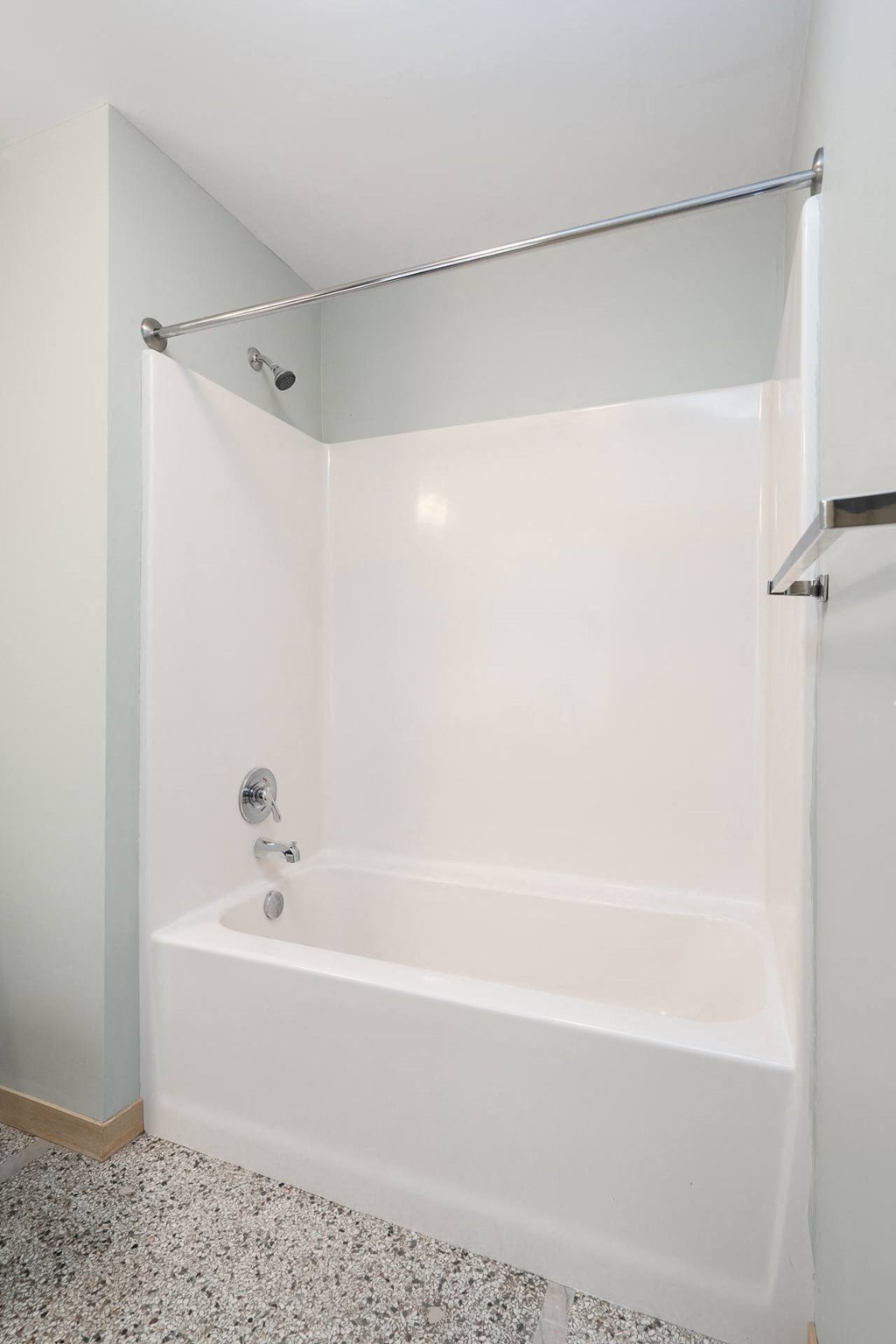 a white tub in a bathroom with a shower curtain