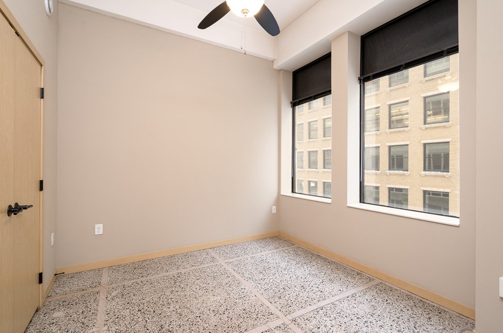 an empty room with tile flooring and a window