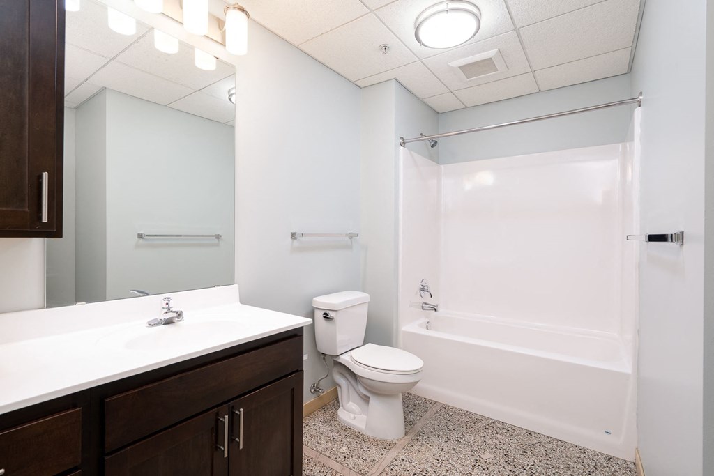 a bathroom with a shower toilet and sink and a mirror