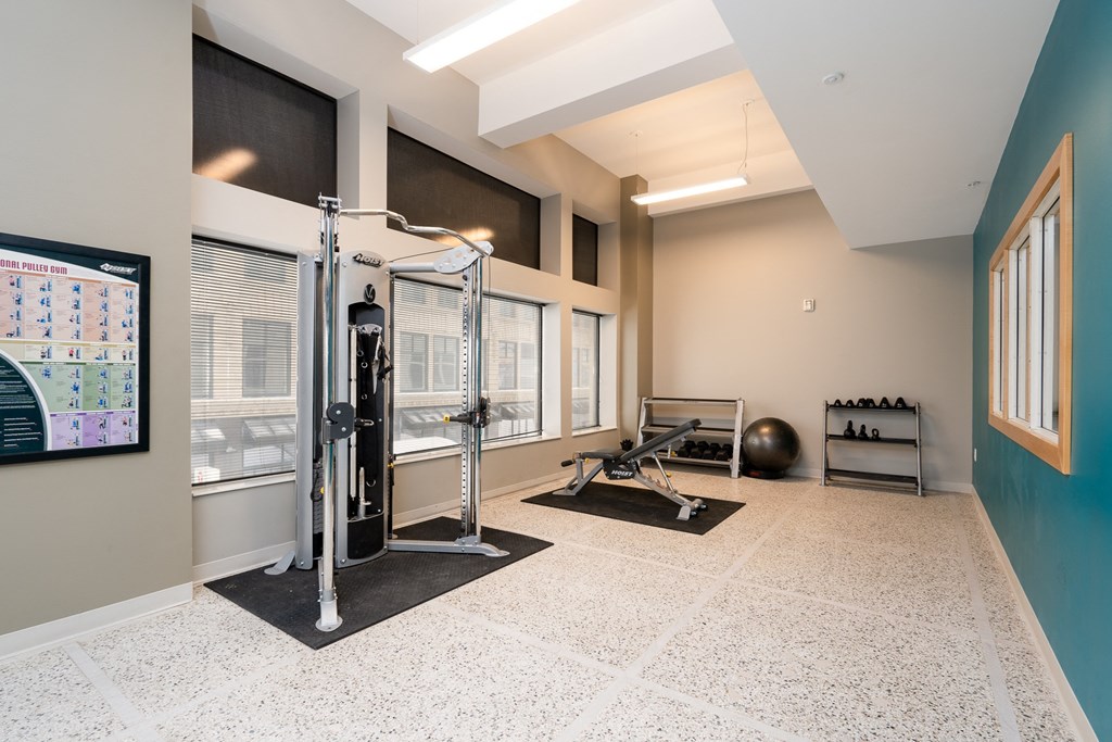 a fitness room with a gym equipment and a large window