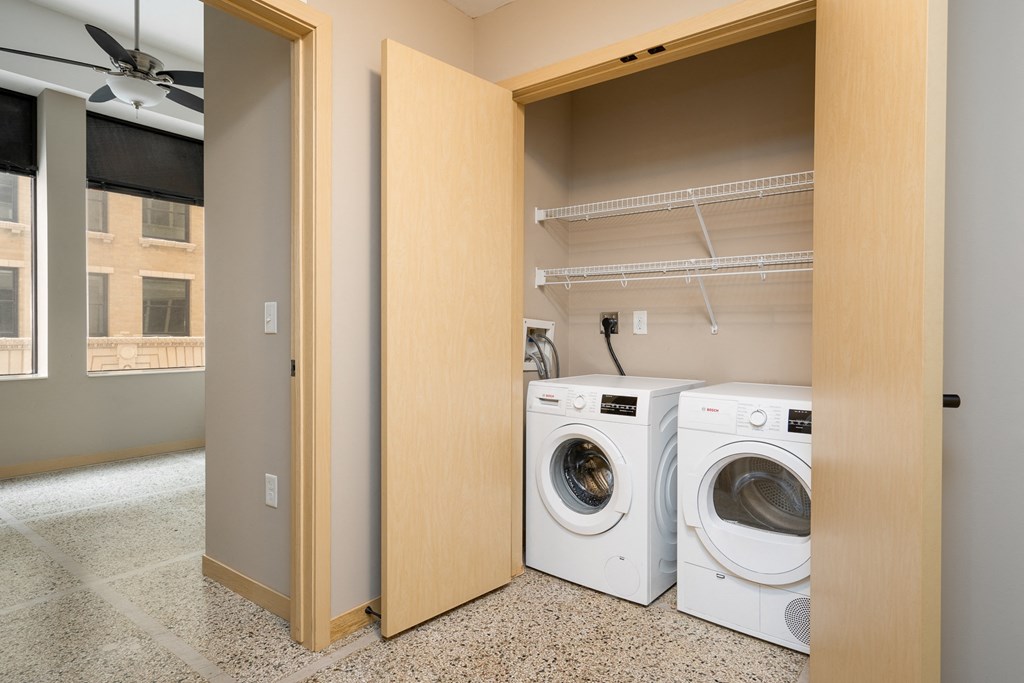 a washer and dryer in a laundry room with a closet