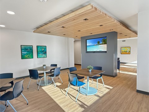 A conference room with a TV screen and chairs.