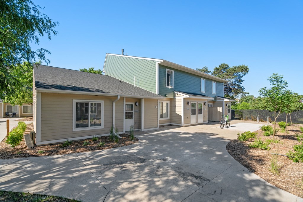 a house with a driveway and a bike parked outside of it