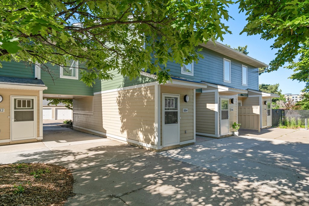 the front of a house with a sidewalk and a driveway
