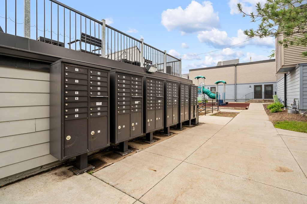 the mailboxes are lined up on the side of the building