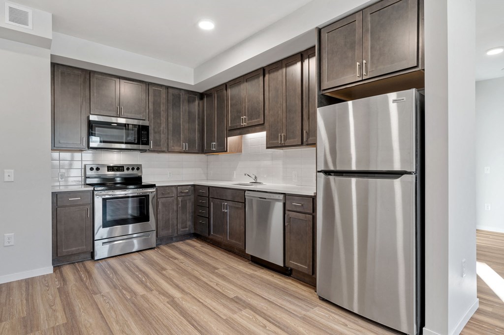 a kitchen with stainless steel appliances and wooden cabinets